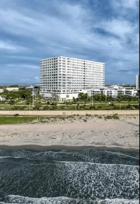 a large white building on the beach next to the water at Modern apartment near the airport in Cartagena de Indias