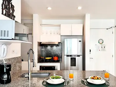 a white kitchen with two plates of food on a counter at Morros Ultra 1 BR - Direct Sea View in Cartagena de Indias