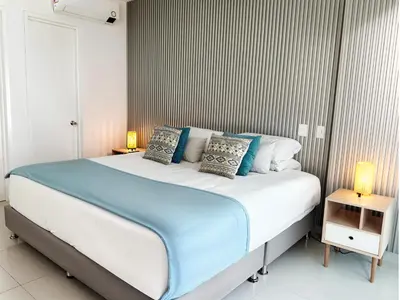 a bedroom with a large bed with two lamps at Morros Ultra 1 BR - Direct Sea View in Cartagena de Indias