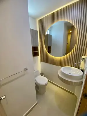 a bathroom with a sink and a toilet and a mirror at Bocagrande Excelente Ubicacion Apto CONFORT con una gran vista al MAR y PLAYAS in Cartagena de Indias