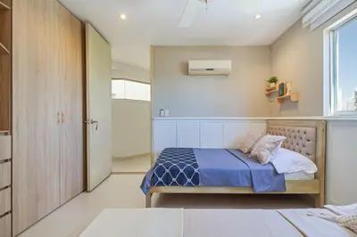 a small bedroom with a bed and a window at Bocagrande Excelente Ubicacion Apto CONFORT con una gran vista al MAR y PLAYAS in Cartagena de Indias