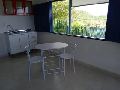a kitchen with a table and two chairs and a window at Liz&Mar Glamping in Tubará