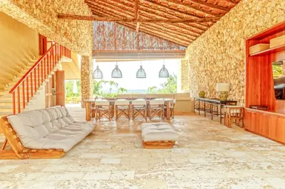 a living room with a couch and a table at Exclusive 4BR Beach House in Tierra Bomba in Tierra Bomba