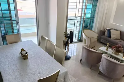 a dining room with a table and a couch at Dúplex Frente al Mar cerca C.Amurallada in Cartagena de Indias