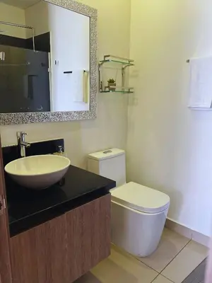 a bathroom with a sink and a toilet and a mirror at Chic Apartment Near It All in Cartagena de Indias