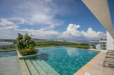 a swimming pool on a building with a view of the ocean at Impresionante vista Dominique 2 suites in Cartagena de Indias