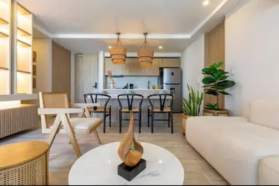 a living room with a white couch and a table at Impresionante vista Dominique 2 suites in Cartagena de Indias