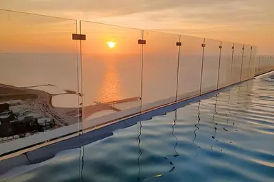 a infinity pool with the sunset in the background at Luxury 2B, stunning View 4 Blocks from walled City in Cartagena de Indias