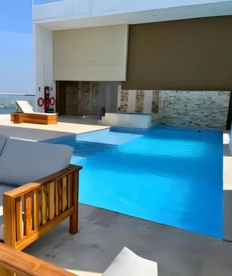 a large swimming pool with blue water in a house at Bay View Duplex in Bocagrande in Cartagena de Indias