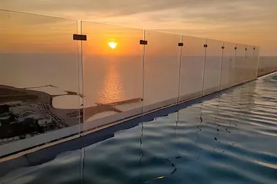 a infinity pool with the sunset in the background at Stuning view to Walled city & Beach, King size bed in Cartagena de Indias