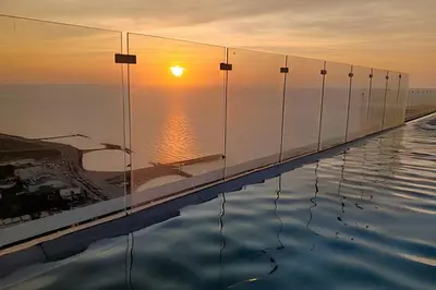a infinity pool with the sunset in the background at Stuning view to Walled city & Beach, King size bed in Cartagena de Indias