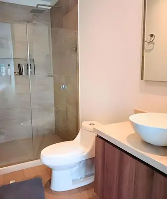 a bathroom with a toilet and a glass shower at Brand New, 3blocks from Walled C, Stunning Views in Cartagena de Indias