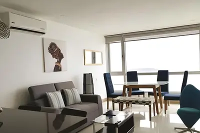 a living room with a couch and a table at Espectacular vista en la mejor zona del Laguito in Cartagena de Indias