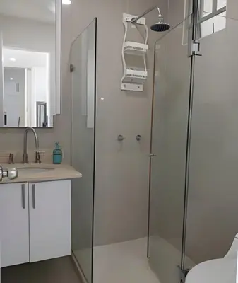 a bathroom with a glass shower and a sink at Precioso apto cama King y con salida a playa in Cartagena de Indias