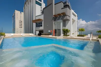 a large swimming pool in front of a building at Ocean Majesty, Luxury Haven close to Walled City in Cartagena de Indias