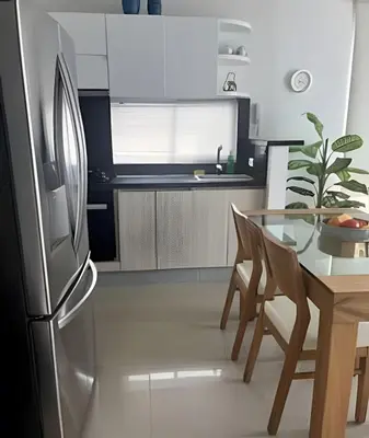 a kitchen with a glass table and a stainless steel refrigerator at Ocean Majesty, Luxury Haven close to Walled City in Cartagena de Indias