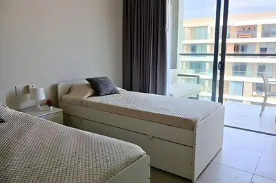 a bedroom with two beds and a large window at Lujo y privacidad, Vista y salida directa al mar in Cartagena de Indias