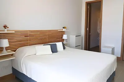 a bedroom with a large white bed with two pillows at Lujo y privacidad, Vista y salida directa al mar in Cartagena de Indias