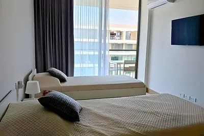a bedroom with two beds and a large window at Lujo y privacidad, Vista y salida directa al mar in Cartagena de Indias