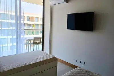 a bedroom with a bed and a tv on a wall at Lujo y privacidad, Vista y salida directa al mar in Cartagena de Indias