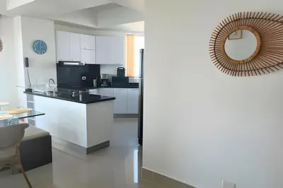 a kitchen with white cabinets and a mirror at Amazing Ocean View, 2B in Bocagrande in Cartagena de Indias