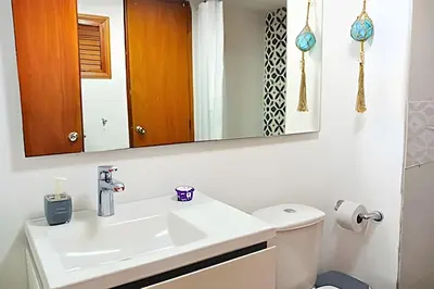 a bathroom with a white sink and a mirror at Precioso Apto a pasos de la playa, ubicación ideal in Cartagena de Indias