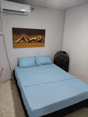 a bedroom with a blue bed in a room at Back house gallery in Cartagena de Indias