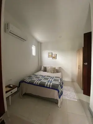 a bedroom with a bed in a white room at Northwest Hostings 4 in Cartagena de Indias