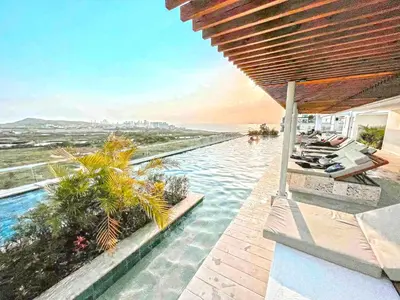 a swimming pool with a view of the ocean at Dominique Luxury - 1 BR - Private Jacuzzi - 13th Floor in Cartagena de Indias