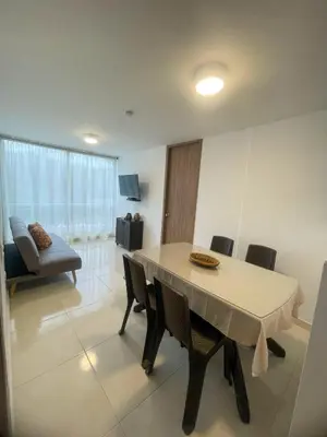 a living room with a table and chairs and a couch at Comfortable and central apartment in Bquilla in Barranquilla