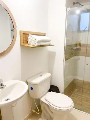 a bathroom with a toilet and a sink and a shower at Comfortable and central apartment in Bquilla in Barranquilla