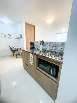 a kitchen with a counter top with a microwave at Comfortable and central apartment in Bquilla in Barranquilla
