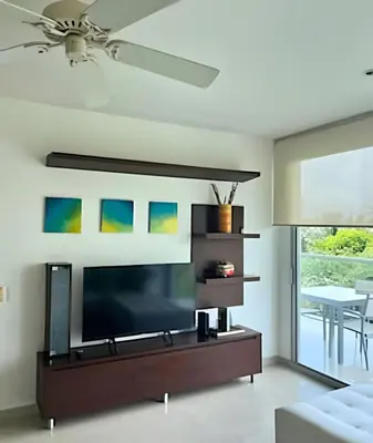 a living room with a large flat screen tv at Beachfront Paradise with Pools and Spa in Cartagena de Indias