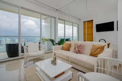 a living room with a couch and some windows at luxury apartemt bay front 1bed 2703 in Cartagena de Indias