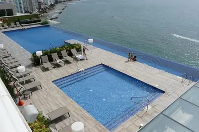an overhead view of a large swimming pool next to the water at luxury apartemt bay front 1bed 2703 in Cartagena de Indias