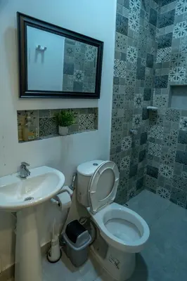 a bathroom with a toilet and a sink and a mirror at Casa Chongui in Lorica
