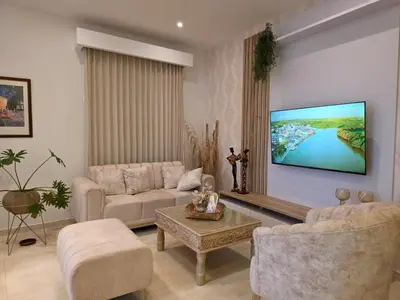 a living room with a couch and a tv on the wall at Casa Chongui in Lorica