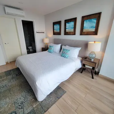 a bedroom with a large white bed and two lamps at View, exit to Playa Morros tres Cartagena in Cartagena de Indias