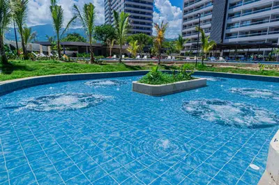 a swimming pool with blue water in a resort at Apto Lujo Vista Mar Piscina AC WIFI Playa a 3 min en Santa Marina in Santa Marta