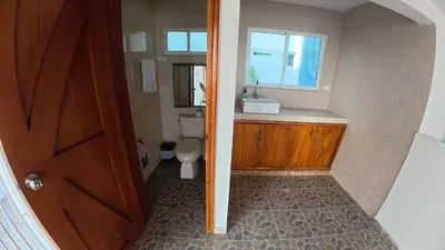 a bathroom with a toilet and a sink and a window at Casa cerca al mar Zona Norte Cielo Mar Cartagena in Cartagena de Indias