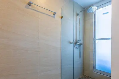 a shower with a glass door in a bathroom at Luxurious Beachfront 3BR, Pool & Ocean Views in Cartagena de Indias