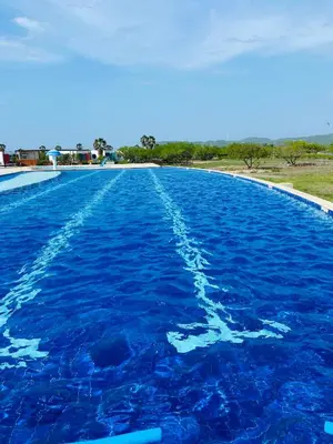 a large swimming pool with blue water in the middle at Cabaña frente al mar in Tubará