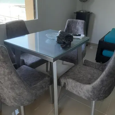 a blue table with two chairs and a glass top at Confortable in Cartagena de Indias