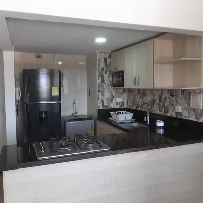 a kitchen with a stove and a refrigerator at Confortable in Cartagena de Indias