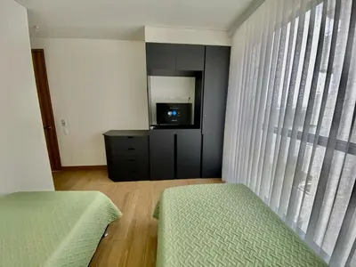 a bedroom with a bed and a tv and a window at Sunsets in El Cabrero - Cartagena in Cartagena de Indias