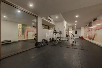 a gym with tread machines and a large mirror at Morros 3, 1 Bedroom & Seaview in Cartagena de Indias