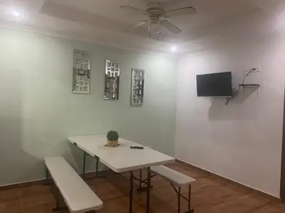 a room with a table and two chairs and a tv at Posada Encanto Cartagena in Cartagena de Indias
