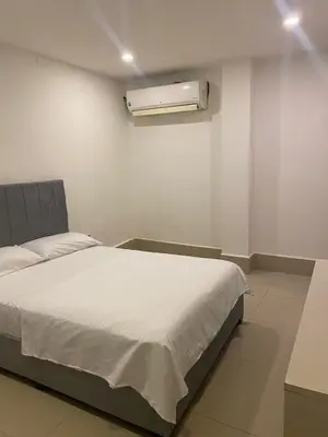 a bedroom with a bed and a air conditioner at La Rosita in Puerto Colombia