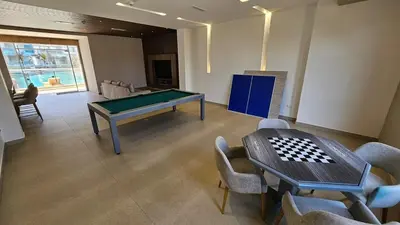a room with a ping pong table and a table and chairs at De Luxe acogedor con vistas al Mar y Atardeceres in Maizal