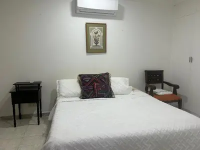a white bed with a pillow on top of it at Cristoforo Colombo CARTAGENA